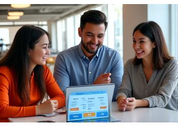 Image of energetic young professionals in a modern office, engaged in financial planning discussions with digital tools.